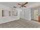Bright bedroom featuring neutral carpet, white walls, and a ceiling fan fixture at 8022 Hogan Dr, Wake Forest, NC 27587
