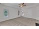 Spacious bedroom with a ceiling fan and neutral carpeting, showcasing a serene atmosphere at 8022 Hogan Dr, Wake Forest, NC 27587