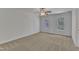 Neutral bedroom features two windows offering natural light and a ceiling fan at 8022 Hogan Dr, Wake Forest, NC 27587