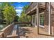 Exterior of brick home showing a deck with built-in seating and natural backdrop at 8022 Hogan Dr, Wake Forest, NC 27587