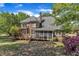 Rear exterior with multi-level deck, screened porch, and beautiful landscaping at 8022 Hogan Dr, Wake Forest, NC 27587