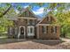 Elegant brick home with a manicured lawn and classic architectural details at 8022 Hogan Dr, Wake Forest, NC 27587