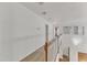 Spacious hallway with hardwood floors, carpet runner, and natural light from rear windows at 8022 Hogan Dr, Wake Forest, NC 27587