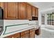 Close-up of kitchen with wood cabinetry and tiled countertops and backsplash with eat-in nook at 8022 Hogan Dr, Wake Forest, NC 27587