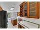 View of kitchen with wood cabinetry, tiled countertops and backsplash, stainless appliances, and eat-in nook at 8022 Hogan Dr, Wake Forest, NC 27587