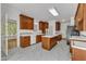 Traditional kitchen with marble floors, wood cabinets, an island cooktop, and modern appliances at 8022 Hogan Dr, Wake Forest, NC 27587