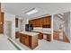Traditional kitchen featuring a central island, wood cabinets, black appliances, and marble flooring at 8022 Hogan Dr, Wake Forest, NC 27587