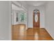 Cozy living space with hardwood floors, white walls, and a large front window at 8022 Hogan Dr, Wake Forest, NC 27587