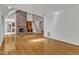 Open living space featuring a brick fireplace, staircase, hardwood floors, and abundant natural light at 8022 Hogan Dr, Wake Forest, NC 27587