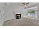 Spacious living room with fireplace, neutral carpet, ceiling fan, and multiple windows at 8022 Hogan Dr, Wake Forest, NC 27587