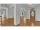 Bright living space with gleaming hardwood floors and an entryway with detailed trim at 8022 Hogan Dr, Wake Forest, NC 27587