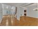 Open-concept living room featuring a brick fireplace, skylights, and hardwood floors for a seamless transition at 8022 Hogan Dr, Wake Forest, NC 27587