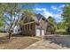 Spacious home with a two-car garage, rear balcony, and lush surrounding landscape at 8022 Hogan Dr, Wake Forest, NC 27587
