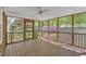 Relaxing screened-in porch offering wooded views and a ceiling fan for added comfort at 8022 Hogan Dr, Wake Forest, NC 27587