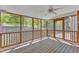 Comfortable screened porch features wood floors, a ceiling fan, and private outdoor views at 8022 Hogan Dr, Wake Forest, NC 27587