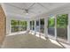 Bright sunroom with multiple sliding doors, offering access to the outdoor deck and natural light at 8022 Hogan Dr, Wake Forest, NC 27587