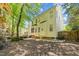 Backyard with patio and mature trees providing shade and privacy. Yellow siding on the house at 8212 Duck Creek Dr, Raleigh, NC 27616