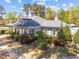 Community clubhouse with manicured landscaping, blue shutters, and a walking path enhancing the property's appeal at 8212 Duck Creek Dr, Raleigh, NC 27616