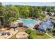 Community pool with cabanas, playground, and clubhouse surrounded by greenery, perfect for Gathering fun at 8212 Duck Creek Dr, Raleigh, NC 27616