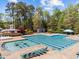 Community pool with lounge chairs surrounded by trees, offering a great place to relax and enjoy the outdoors at 8212 Duck Creek Dr, Raleigh, NC 27616