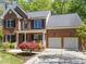 Charming two-story brick home with an attached two-car garage and well-manicured landscaping at 8212 Duck Creek Dr, Raleigh, NC 27616