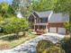 Beautiful brick home with a two-car garage, landscaped yard, and mature trees at 8212 Duck Creek Dr, Raleigh, NC 27616