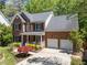 Beautiful two-story brick home with a manicured front lawn, mature landscaping, and a two-car garage at 8212 Duck Creek Dr, Raleigh, NC 27616
