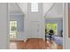 Bright foyer with hardwood floors and access to an office area at 8212 Duck Creek Dr, Raleigh, NC 27616
