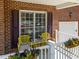 The front porch has yellow metal furniture and flower boxes with colorful flowers at 8212 Duck Creek Dr, Raleigh, NC 27616