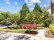 Beautifully landscaped front yard with a red Japanese maple tree and a sidewalk leading to the house at 8212 Duck Creek Dr, Raleigh, NC 27616