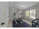 Home gym featuring weight training equipment, large windows, and good lighting at 8212 Duck Creek Dr, Raleigh, NC 27616