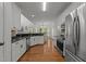 Bright kitchen boasts stainless appliances, white cabinetry, and granite countertops at 8212 Duck Creek Dr, Raleigh, NC 27616