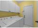 Functional laundry room with a washer, dryer, and plenty of cabinet space at 8212 Duck Creek Dr, Raleigh, NC 27616