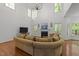 Bright living room with fireplace, many windows, and a large, comfortable sofa at 8212 Duck Creek Dr, Raleigh, NC 27616