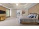 Spacious main bedroom featuring trey ceilings, ensuite bathroom, and neutral color palette at 8212 Duck Creek Dr, Raleigh, NC 27616