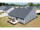 Aerial view of the home showcasing gray siding, a patio set, and landscaping at 8764 Kenridge Ln, Fuquay Varina, NC 27526