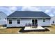 Backyard featuring a patio set, gray siding, and well maintained landscaping at 8764 Kenridge Ln, Fuquay Varina, NC 27526