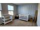 Sweet Bedroom featuring a crib, changing table, neutral tones and natural light at 8764 Kenridge Ln, Fuquay Varina, NC 27526