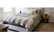 Neutral bedroom showcasing a comfortable bed with decorative pillows and a cozy blanket at 8764 Kenridge Ln, Fuquay Varina, NC 27526
