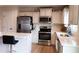 Bright kitchen with white cabinets, stainless steel appliances, and quartz countertops at 8764 Kenridge Ln, Fuquay Varina, NC 27526