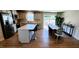 Open kitchen layout with white cabinets, a center island, stainless appliances and an adjacent dining area at 8764 Kenridge Ln, Fuquay Varina, NC 27526