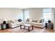 Cozy living room featuring hardwood floors, neutral-colored sofas, and a wooden coffee table at 8764 Kenridge Ln, Fuquay Varina, NC 27526