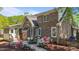 Brick home featuring a charming backyard with a patio, outdoor seating, and beautiful flowering shrubs at 903 Oldwyck Dr, Fuquay Varina, NC 27526