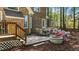 Brick home with a backyard featuring a stone patio, outdoor seating, and a charming stone firepit at 903 Oldwyck Dr, Fuquay Varina, NC 27526