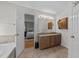 Bathroom featuring a double vanity with granite countertops and wood cabinets at 903 Oldwyck Dr, Fuquay Varina, NC 27526