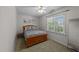 Bedroom with a wood bed frame, neutral carpet, and a bright window at 903 Oldwyck Dr, Fuquay Varina, NC 27526
