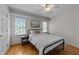 Bedroom with a metal bed frame, hardwood floors, and bright windows at 903 Oldwyck Dr, Fuquay Varina, NC 27526