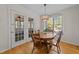 Cozy dining room featuring natural lighting, hardwood floors, and traditional wood table at 903 Oldwyck Dr, Fuquay Varina, NC 27526