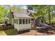 Back of home with a sunroom, patio with dining table, and a fire pit at 903 Oldwyck Dr, Fuquay Varina, NC 27526