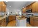 Traditional kitchen featuring hardwood floors, granite countertops, and a central island at 903 Oldwyck Dr, Fuquay Varina, NC 27526